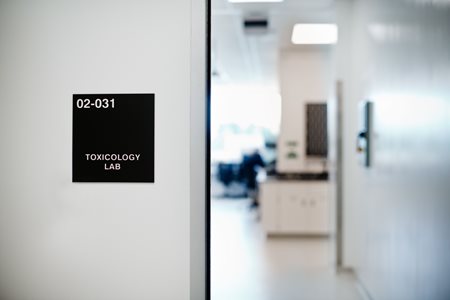 black sign outside toxicology lab